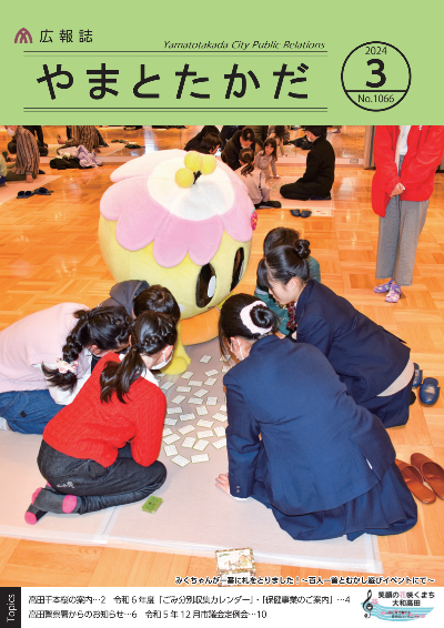 広報誌3月号表紙 市民交流センターで行われた百人一首のイベントにて、高校生やこどもたち、大和高田市のマスコットキャラクターみくちゃんが百人一首を楽しんでいる様子。